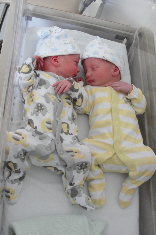 George models this season's must-have elephant motif sleepsuit, while Robin looks splendid in yellow stripes